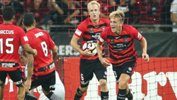 Lachlan Scott celebrates with teammates after scoring against Melbourne City in Round 7.
