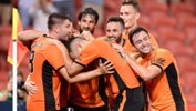 Roar players celebrate a goal in their 2-1 win over Western Sydney in Round 17.