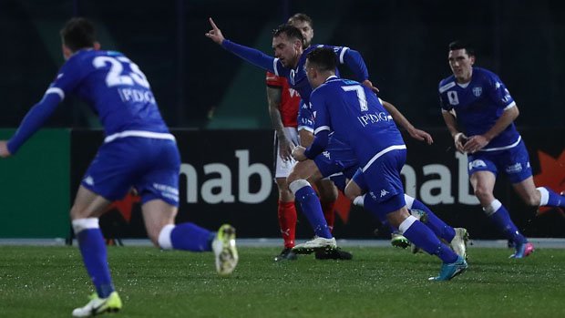 South Melbourne players celebrate Milos Lujic's late strike against Edgeworth FC.