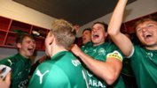 Bentleigh Greens players celebrate in the changerooms after their penalty-shootout win over Hume City.