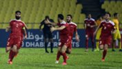 Syria players celebrate a goal against China in Malaysia.