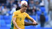 Caltex Socceroos' left wing-back Alex Gersbach wins a header during the first half.