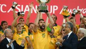 Socceroos skipper Mile Jedinak lifts the AFC Asian Cup.