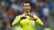 FIFA referee Mark Clattenburg gestures for a football during the Euro 2016 final.