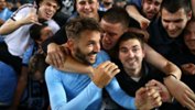 Milos Ninkovic is swamped by Sky Blues fans after full-time in the Sydney Derby.