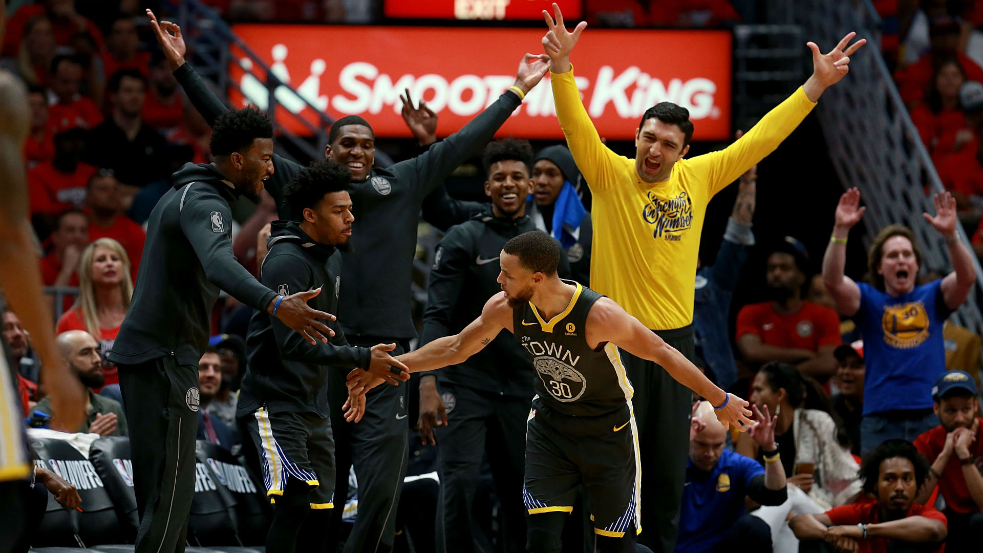 Warriors guard Stephen Curry celebrates with Golden State bench