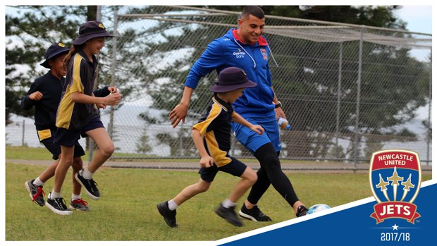 Andrew Nabbout playing football with kids at Port Macquarie Public School on Tuesday