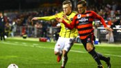 Phoenix's Scott Galloway fights for possession with Western Sydney Wanderers' Josh Risdon.