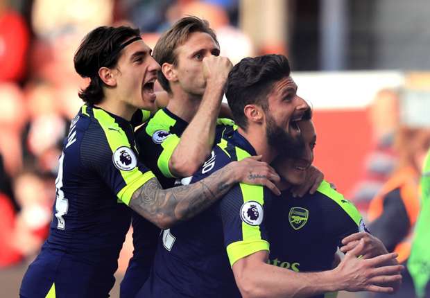 Arsenal players celebrate Mesut Ozil's goal against Stoke City