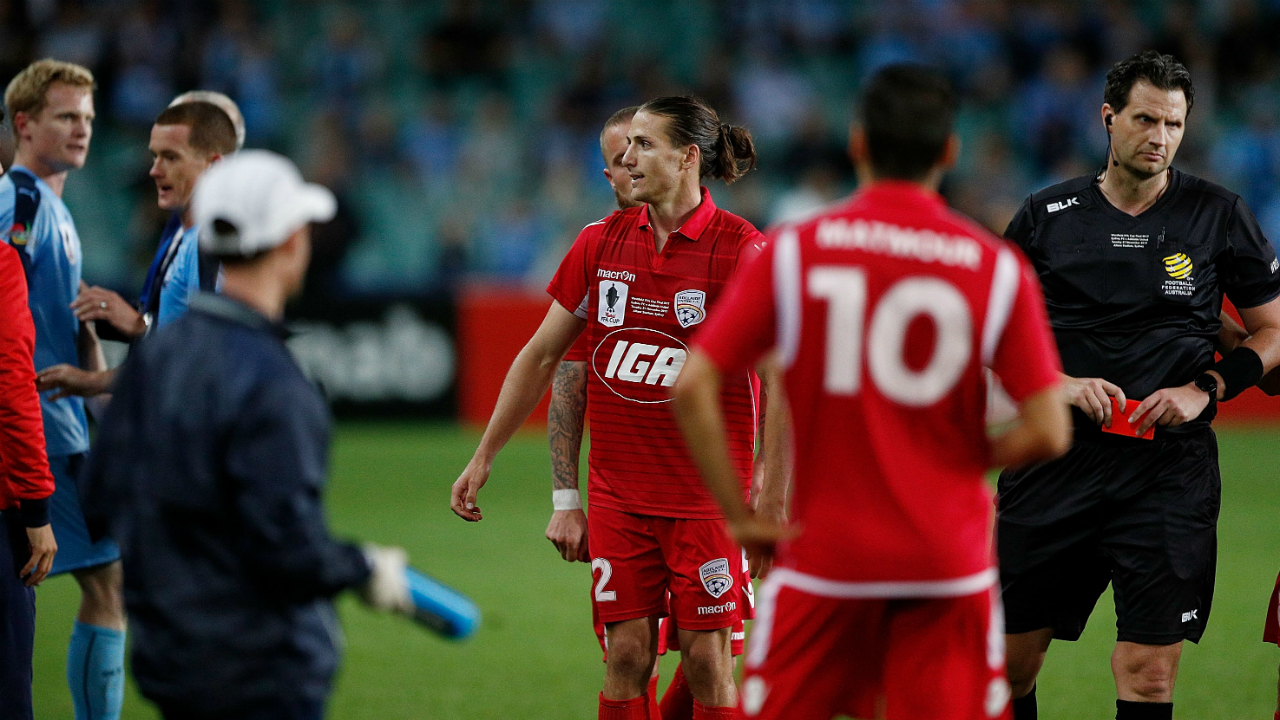 Australian soccer player gets red card after tackling a ball boy