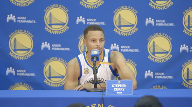 Curry will stand for national anthem