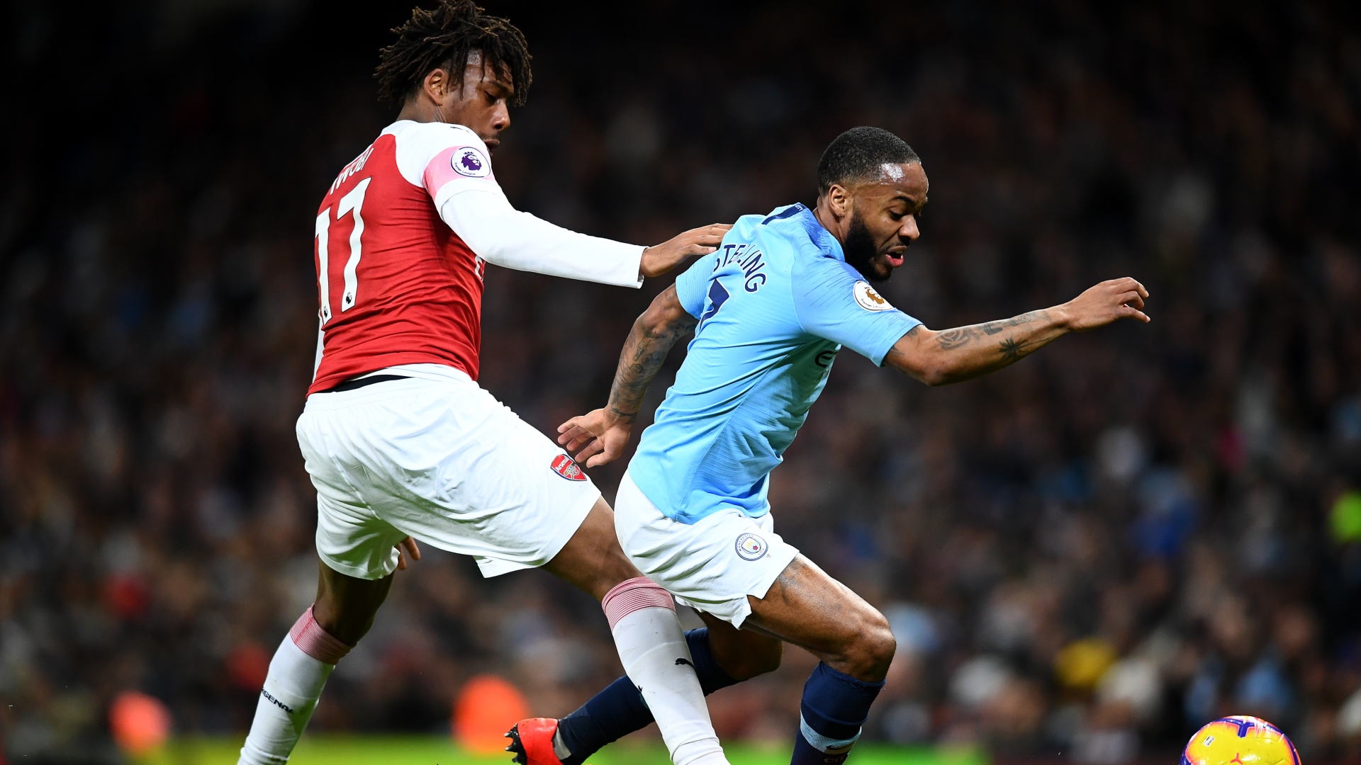 Alex Iwobi of Arsenal, Manchester City's Raheem Sterling