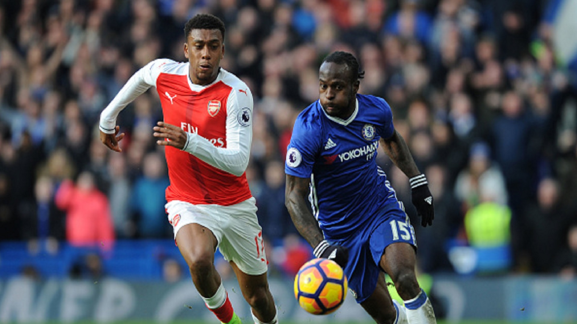 Alex Iwobi of Arsenal takes on Victor Moses of Chelsea during the Premier League match February 2017