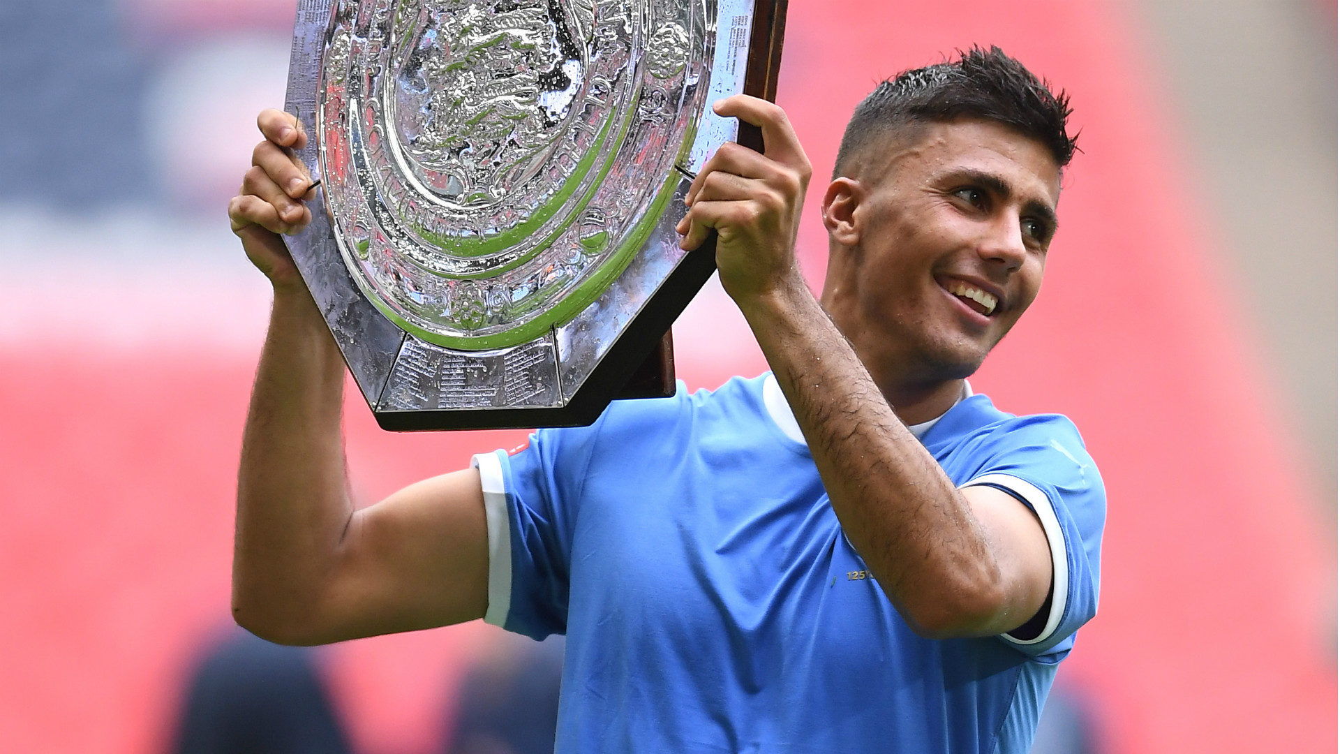  Rodri holds the FA Community Shield trophy aloft after Manchester City's victory over Liverpool at Wembley Stadium.