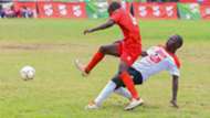 Alex Maundu of Goseta Boys High School (left) challenges Samuel Waka of Koyonzo Boys High School in the COPA Coca-Cola Under 16.
