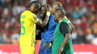 Edmore Sibanda (c) of Zimbabwe leaving the field after being injured.