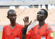 Referee Malong Ring Nyier (R) from South Sudan toss a coin before his assistant Kakunze Herve from Burundi before Telecom FC v Gor Mahia kick-off.