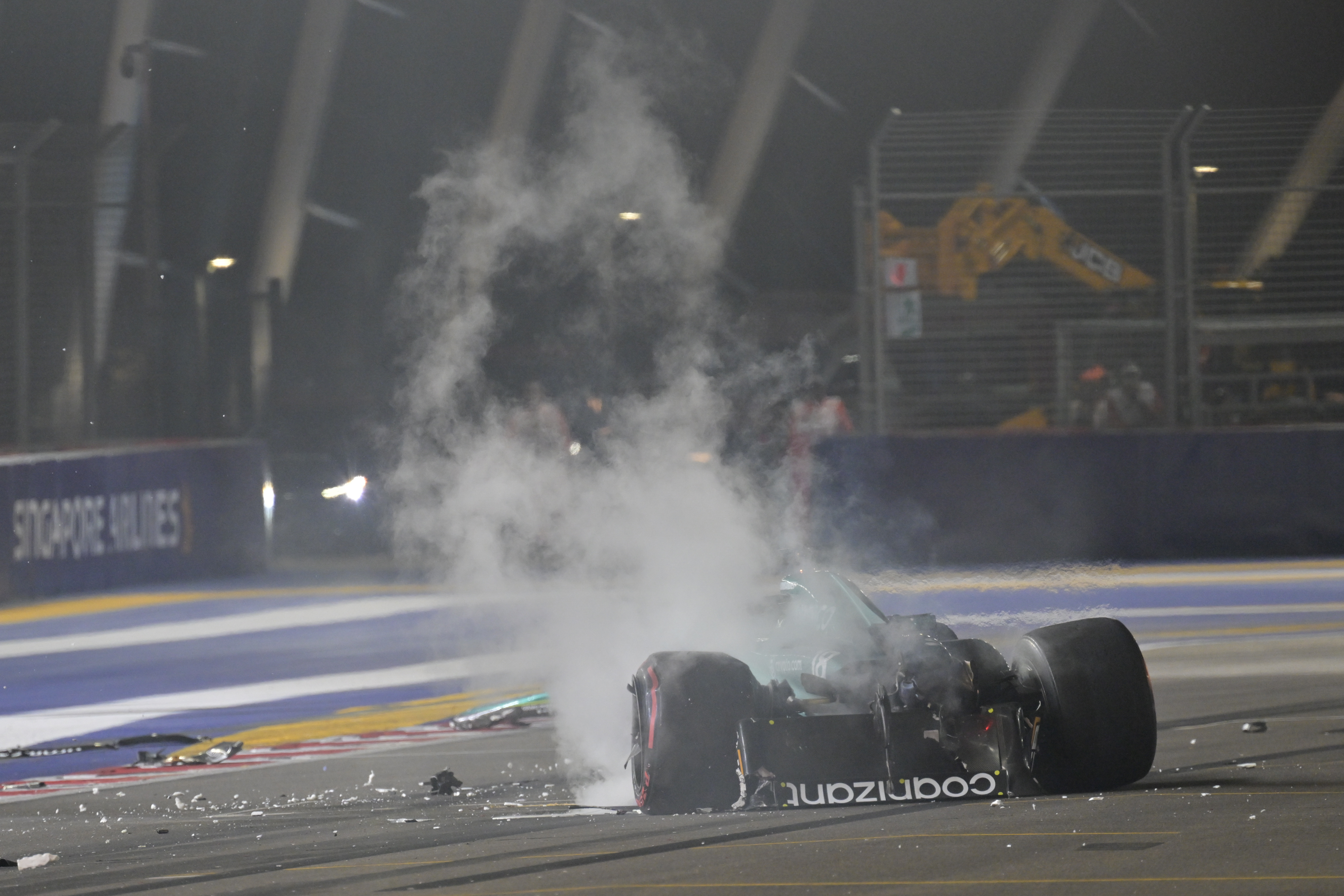 Smoke billows from Lance Stroll's Aston Martin