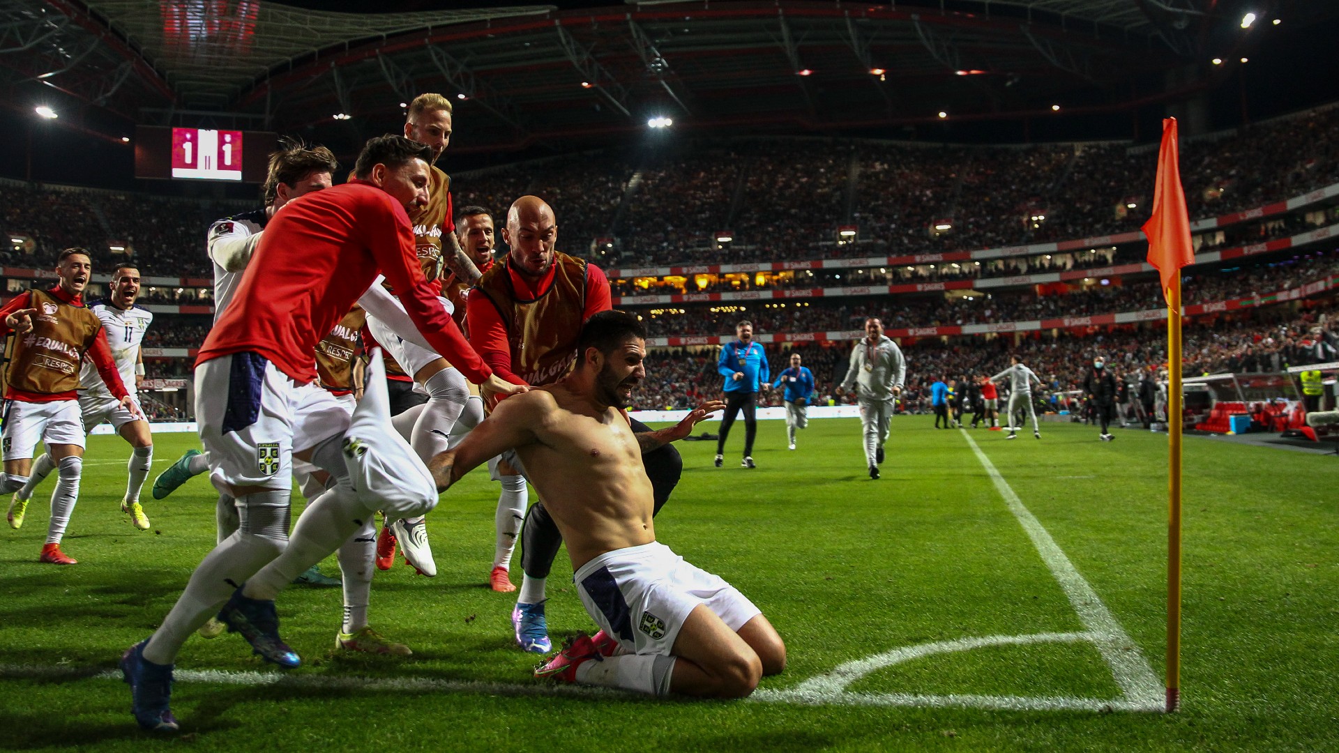 Aleksandar Mitrovic was mobbed by team-mates after scoring a late winner for Serbia in Lisbon