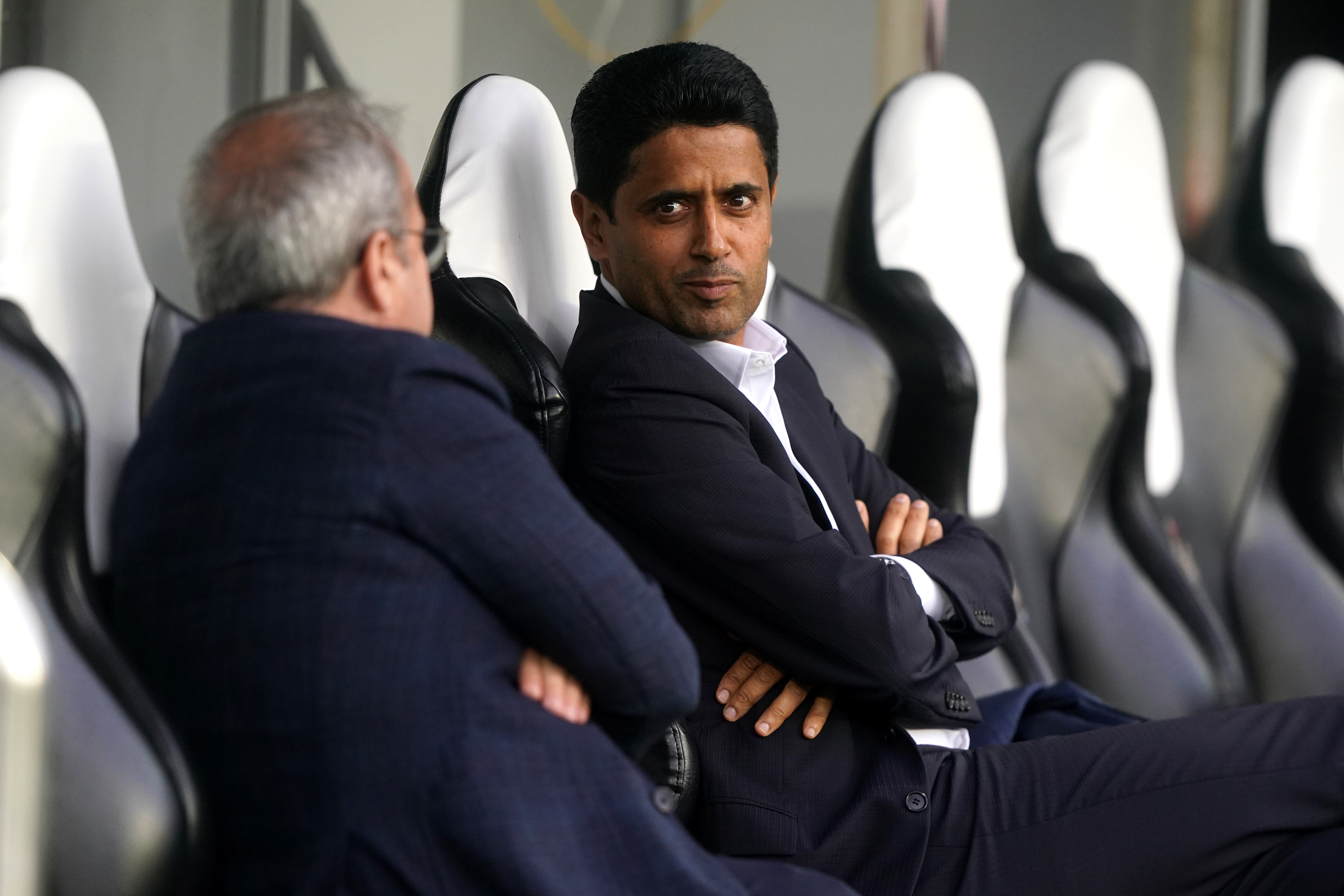 Paris Saint-Germain president Nasser Al-Khelaifi (centre) sits on the bench during a training session