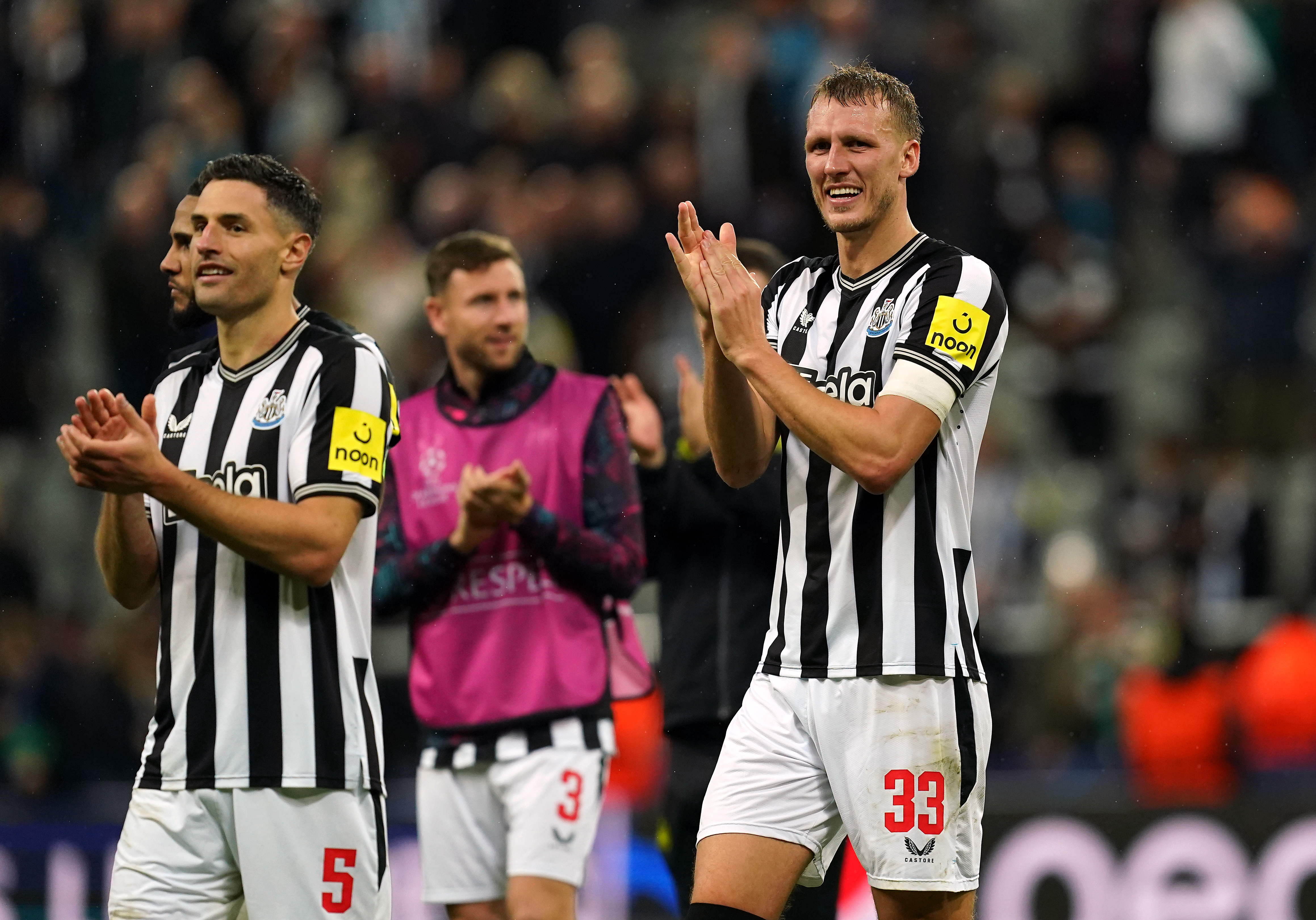 Newcastle's Dan Burn applauds the fans after the Champions League victory over Paris St Germain
