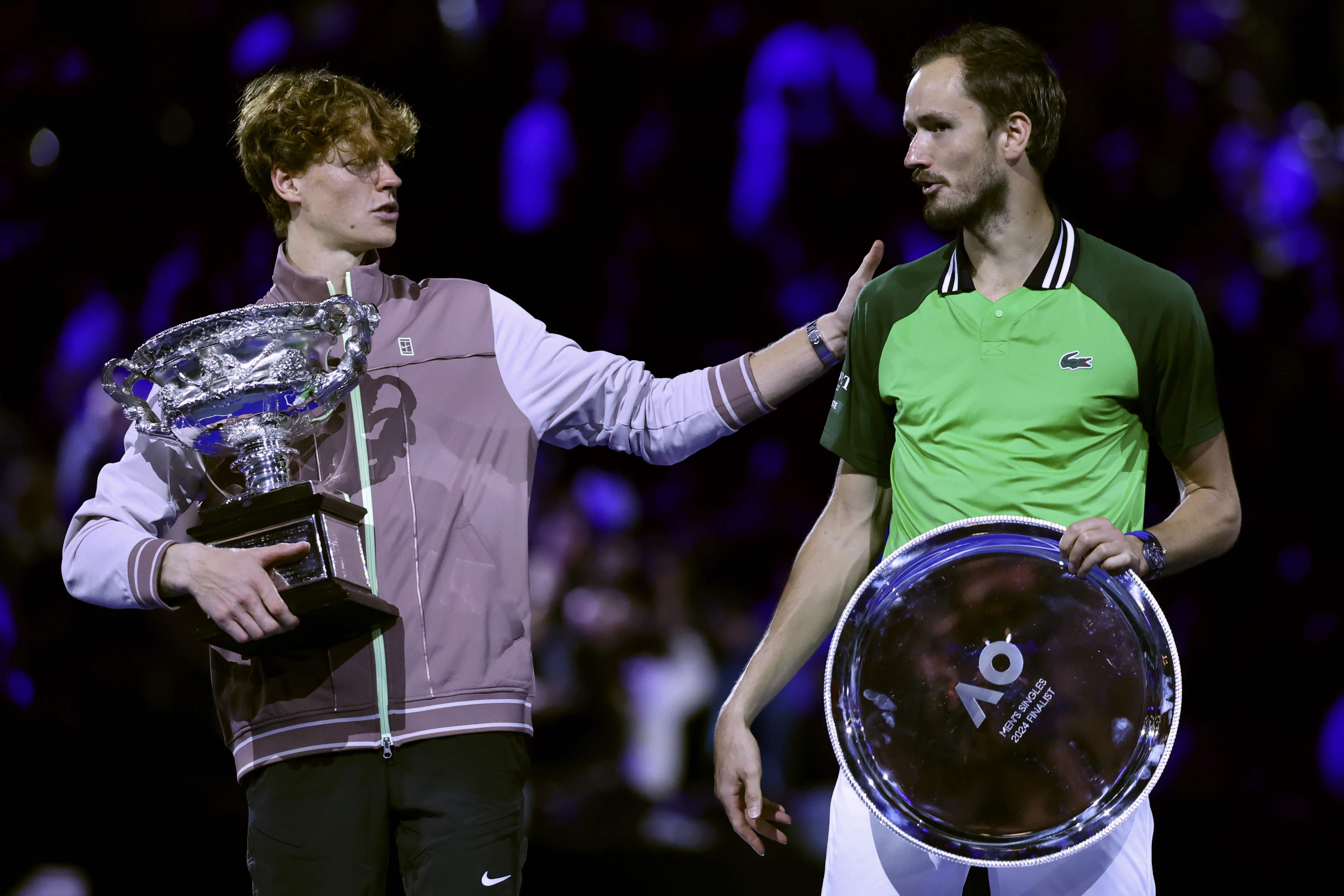 Jannik Sinner, left, consoles Daniil Medvedev