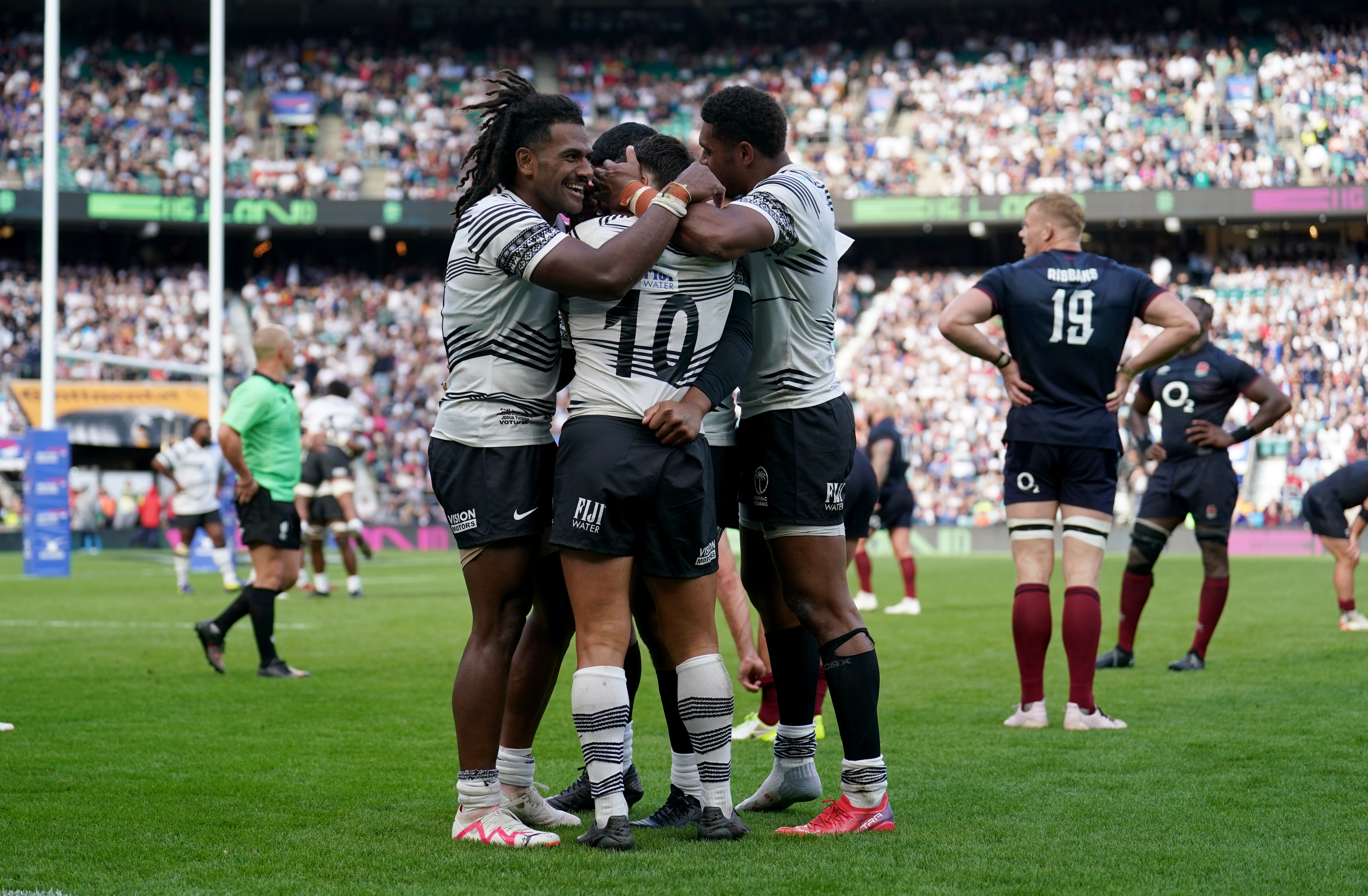 Fiji players celebrate after beating England in August