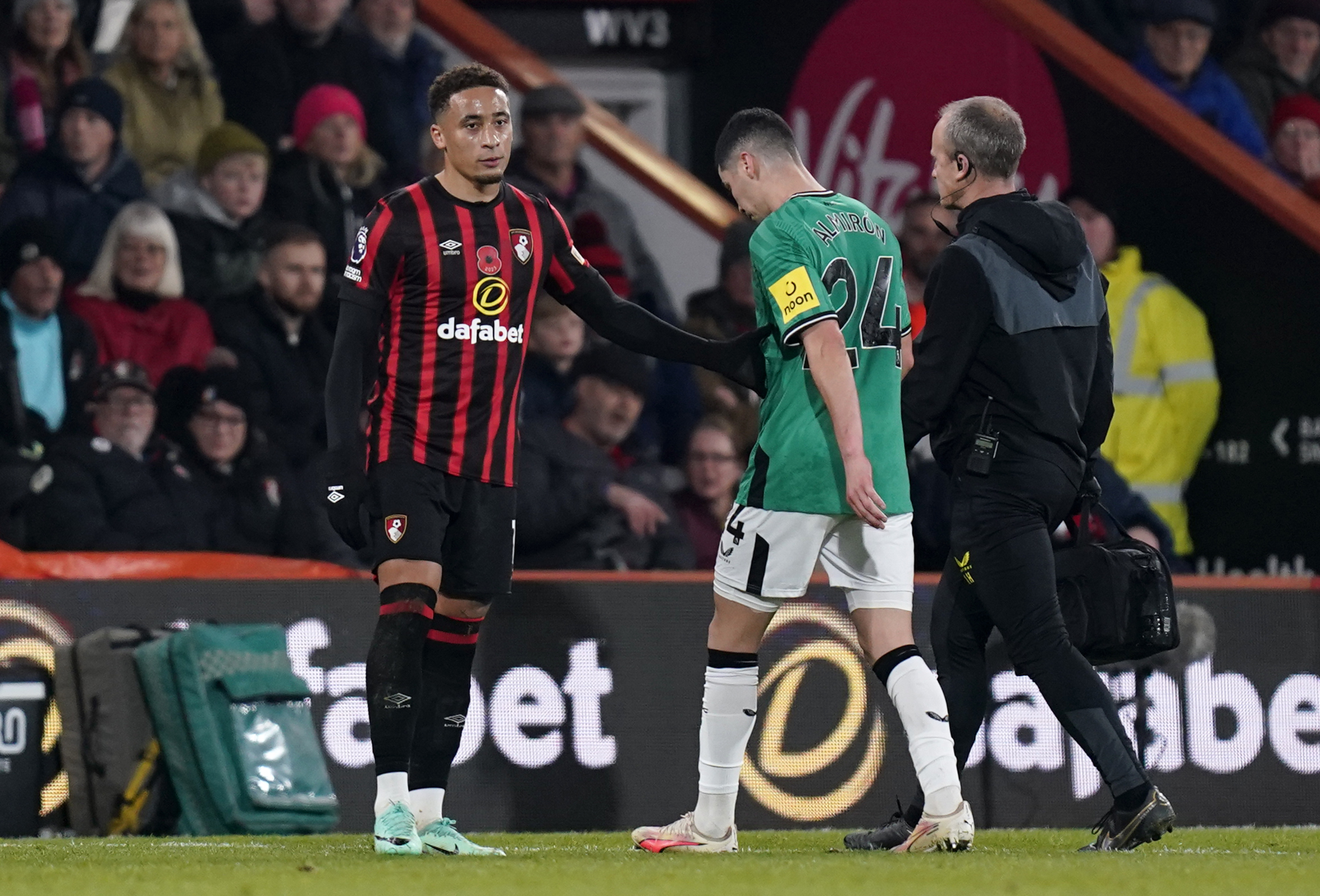 Newcastle’s Miguel Almiron is consoled by Bournemouth’s Marcus Tavernier as he leaves the pitch injured