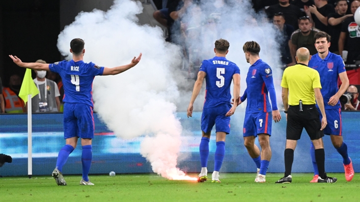 England's players react to a flare being launched onto the field