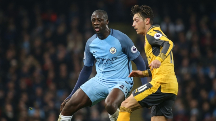 Yaya Toure (L) paid tribute to Mesut Ozil (R) after the former Arsenal midfielder retired