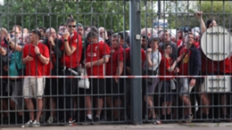 Liverpool fans wait patiently outside the Stade de France