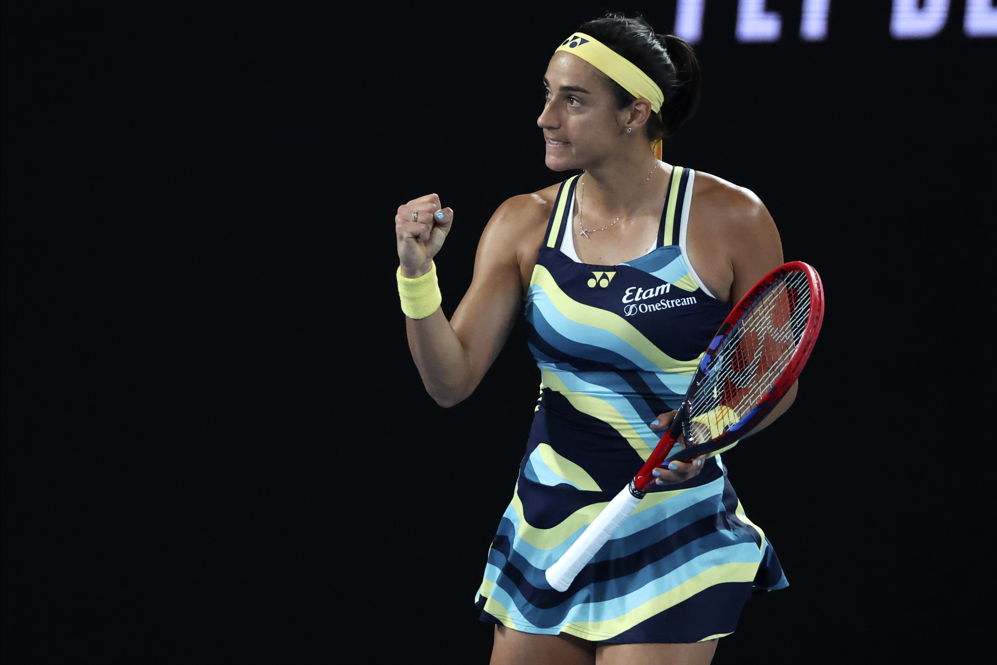 Caroline Garcia clenches her fist after winning the first set