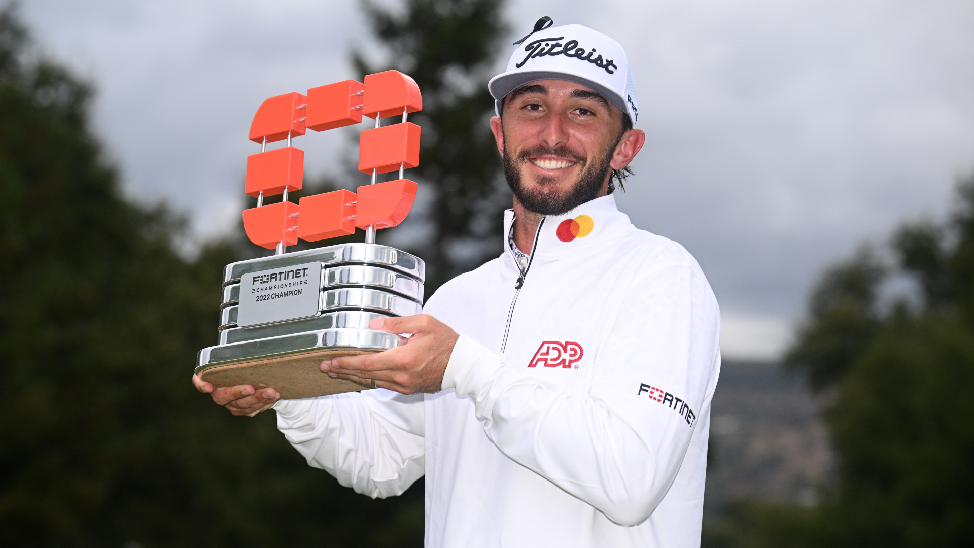 Max Homa lifts the trophy after winning the Fortinet Championship