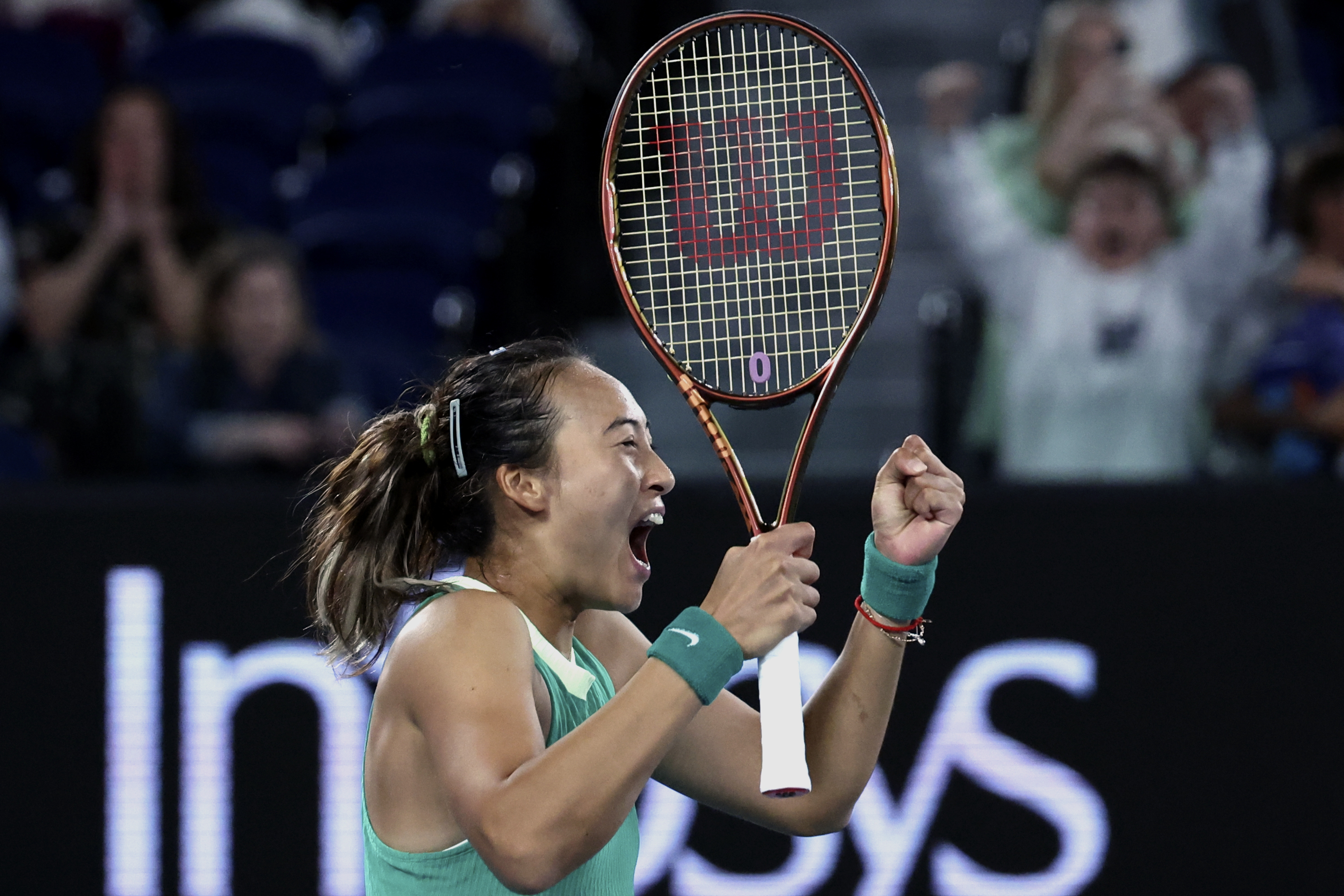 A delighted Zheng Qinwen celebrates beating Dayana Yastremska