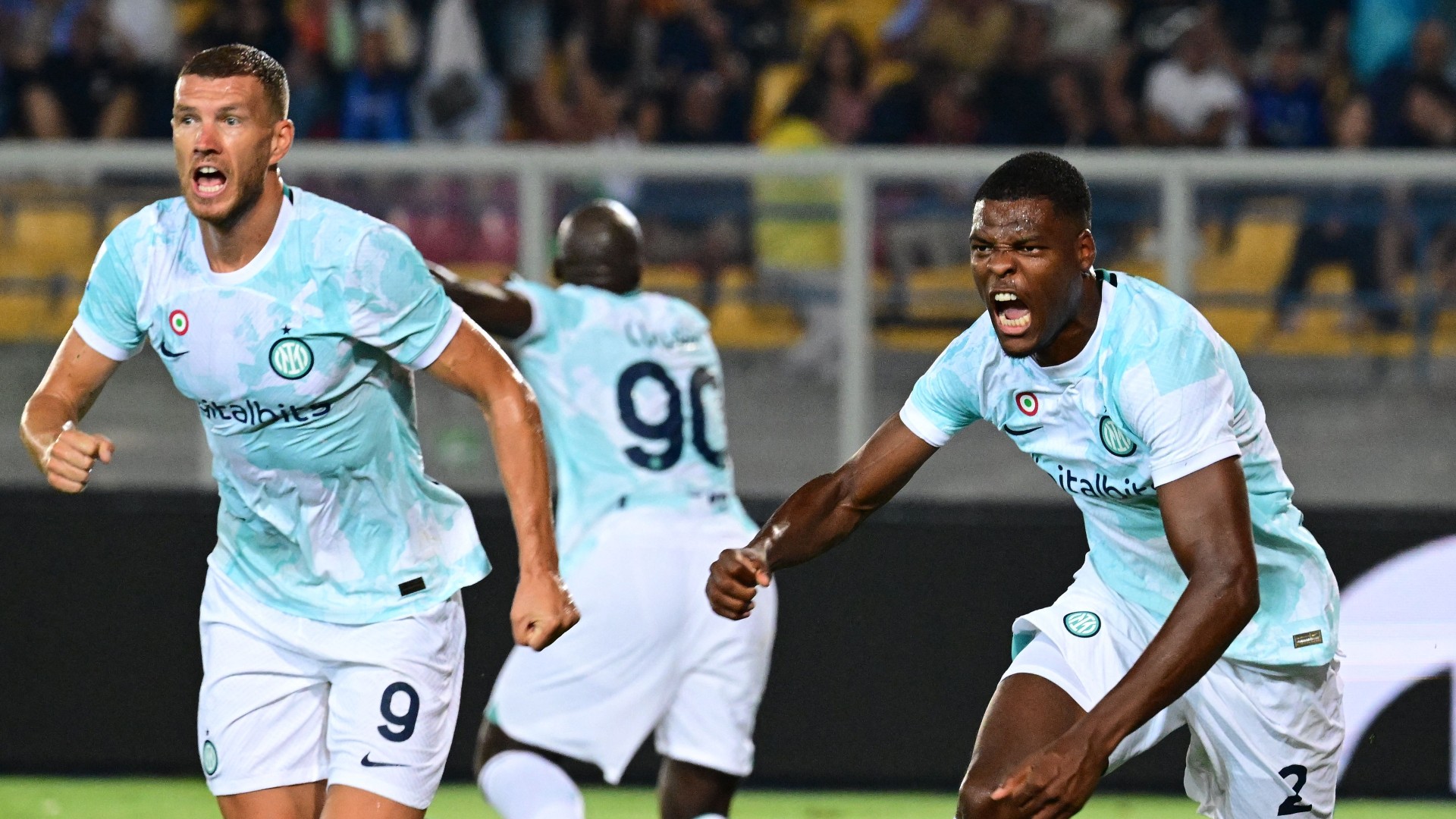 Denzel Dumfries celebrates with fellow Inter substitute Edin Dzeko after scoring against Lecce