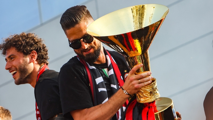 Olivier Giroud celebrates with the Serie A trophy after Milan's league title win