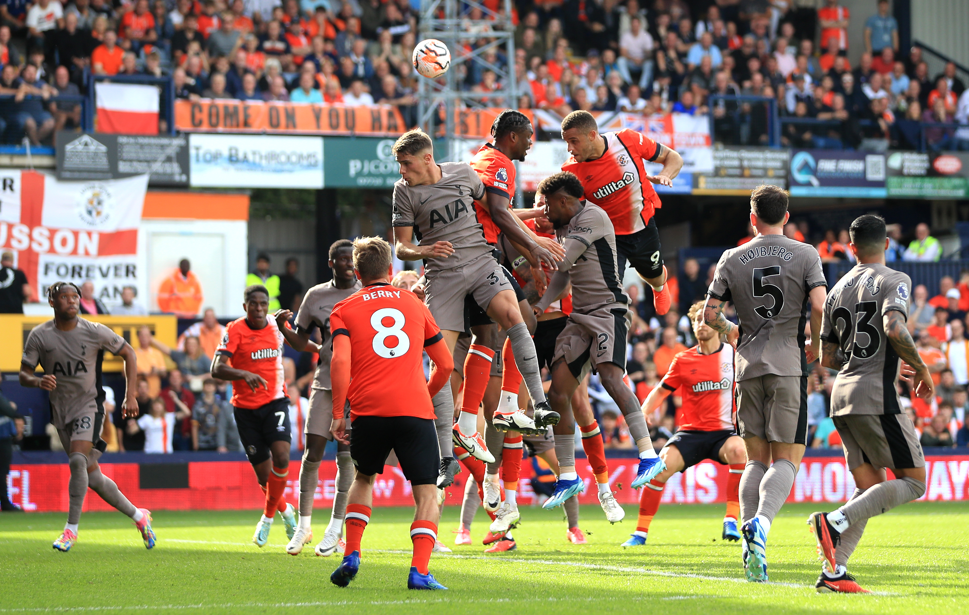 Carlton Morris, centre right, attempts a header against Spurs