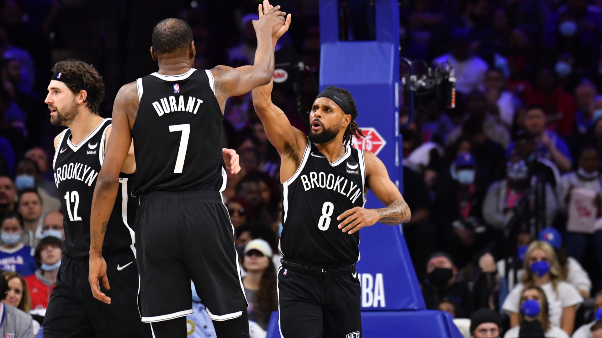 Brooklyn Nets star Kevin Durant (L) and Patty Mills (R)