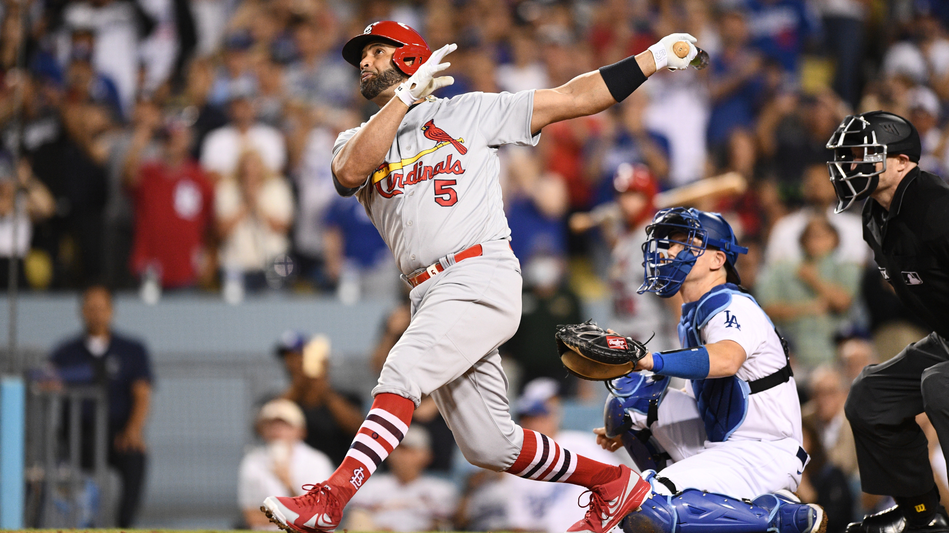 Albert Pujols holds his follow-through after connecting on his 700th home run