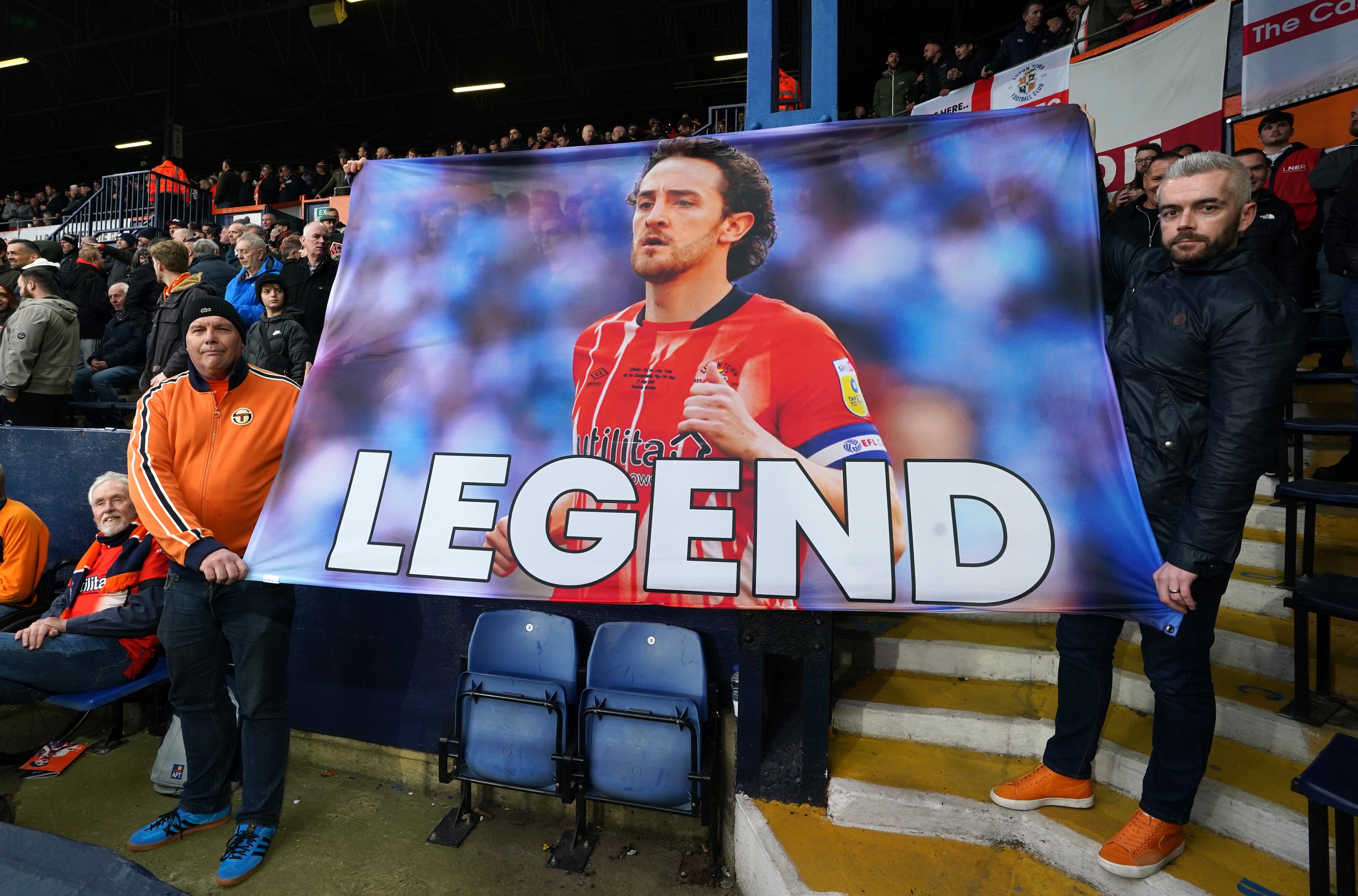 Luton fans hold up a banner of support for Tom Lockyer