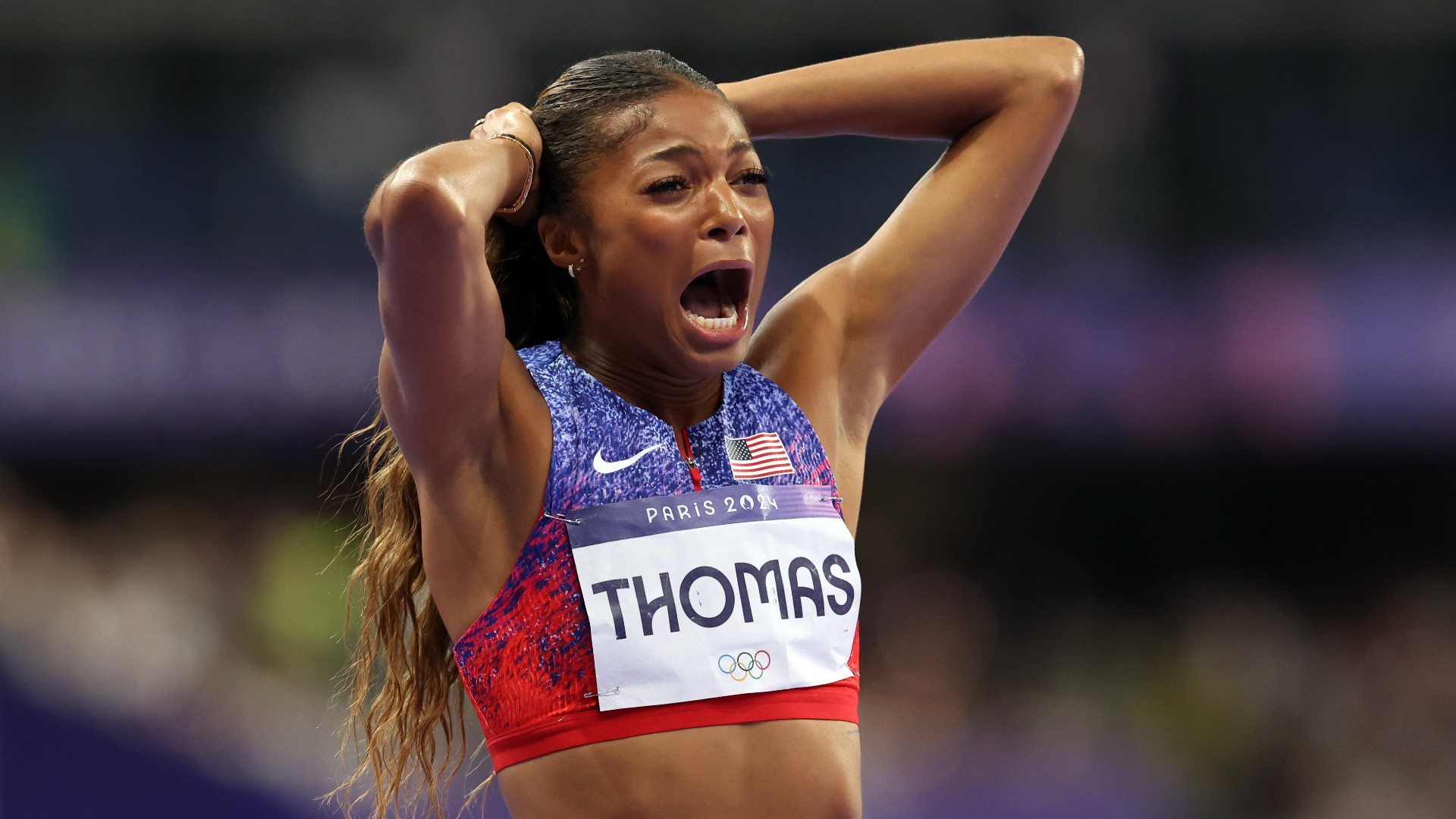 Thomas storms to women's 200m gold