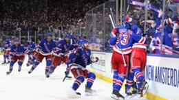 New York Rangers players mob Artemi Panarin after his goal in OT on Sunday