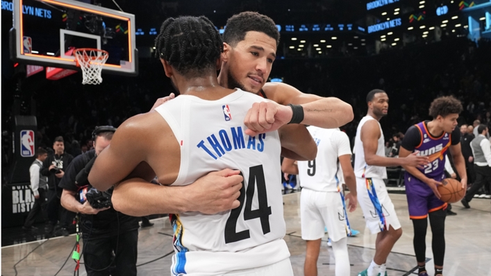 Devin Booker embraces Cam Thomas after the Nets guard made history in a loss