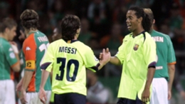 Lionel Messi (L) and Ronaldinho playing together for Barcelona in 2005
