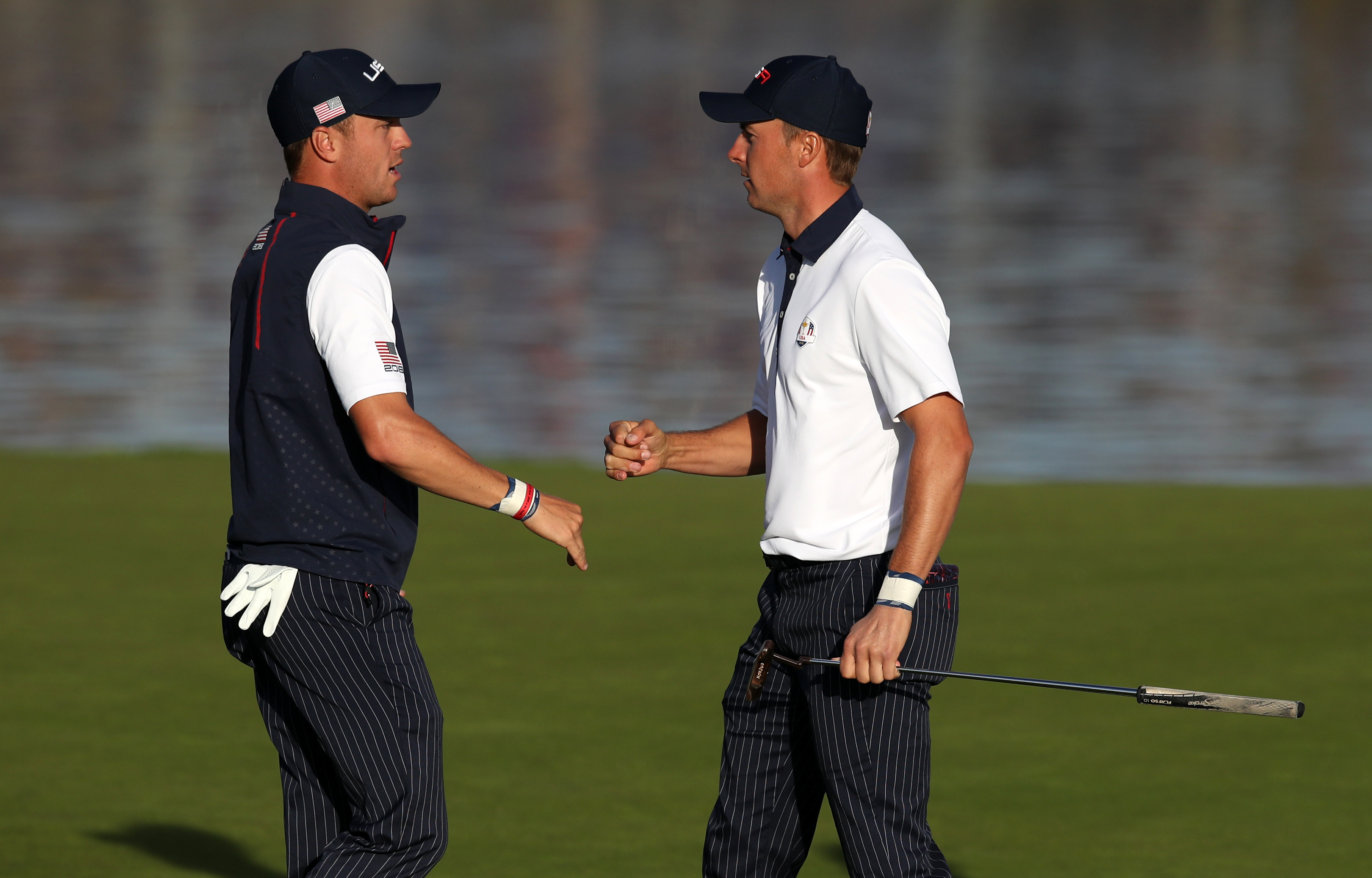 Justin Thomas, left, and Jordan Spieth fist-bumb during the 2018 Ryder Cup