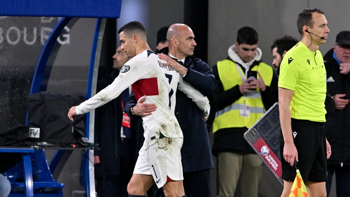Cristiano Ronaldo (L) hugs Roberto Martinez (R) after being brought off during Portugal's 6-0 win at Luxembourg