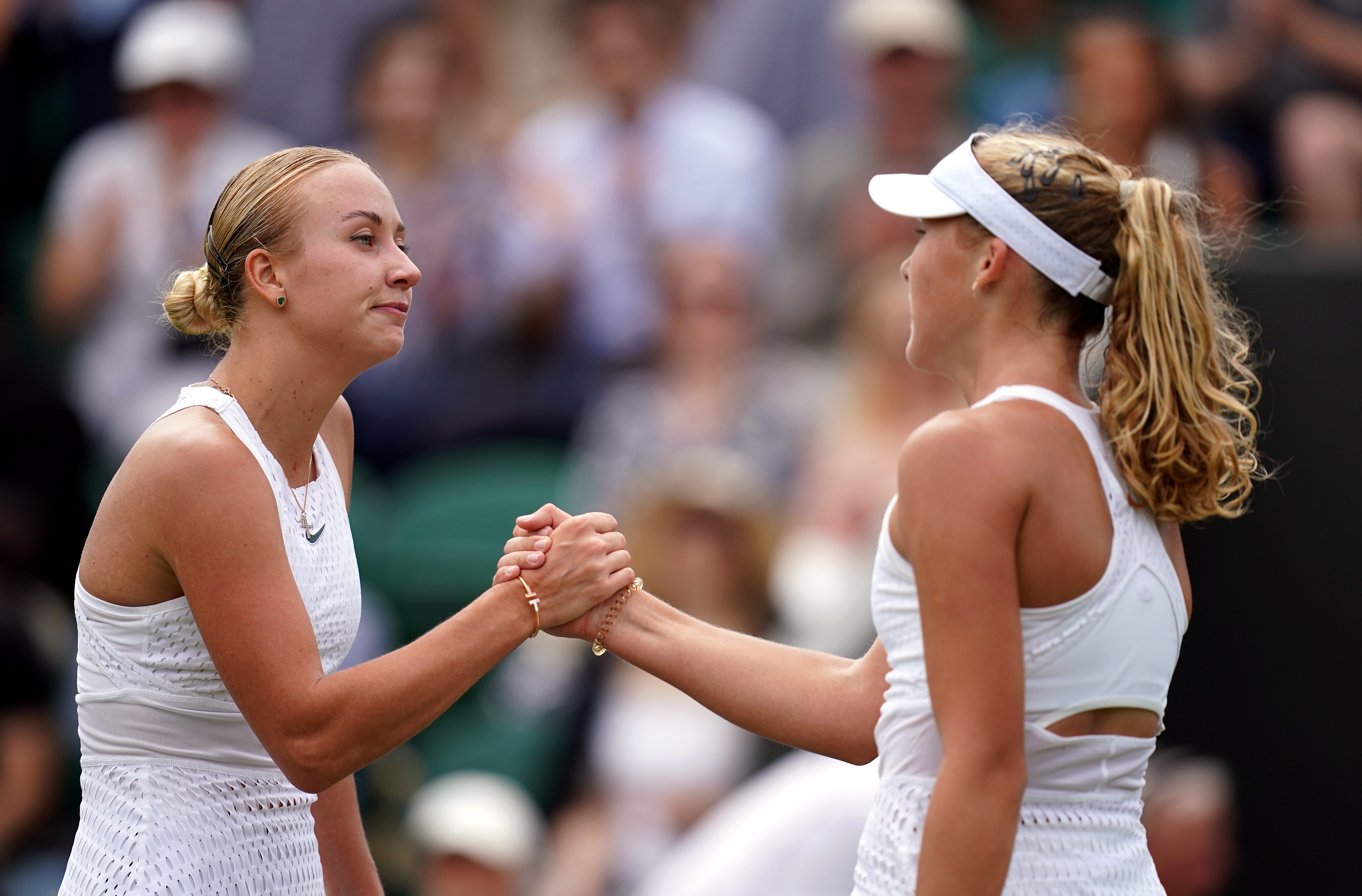 Mirra Andreeva (right) and Anastasia Potapova shake hands after their match