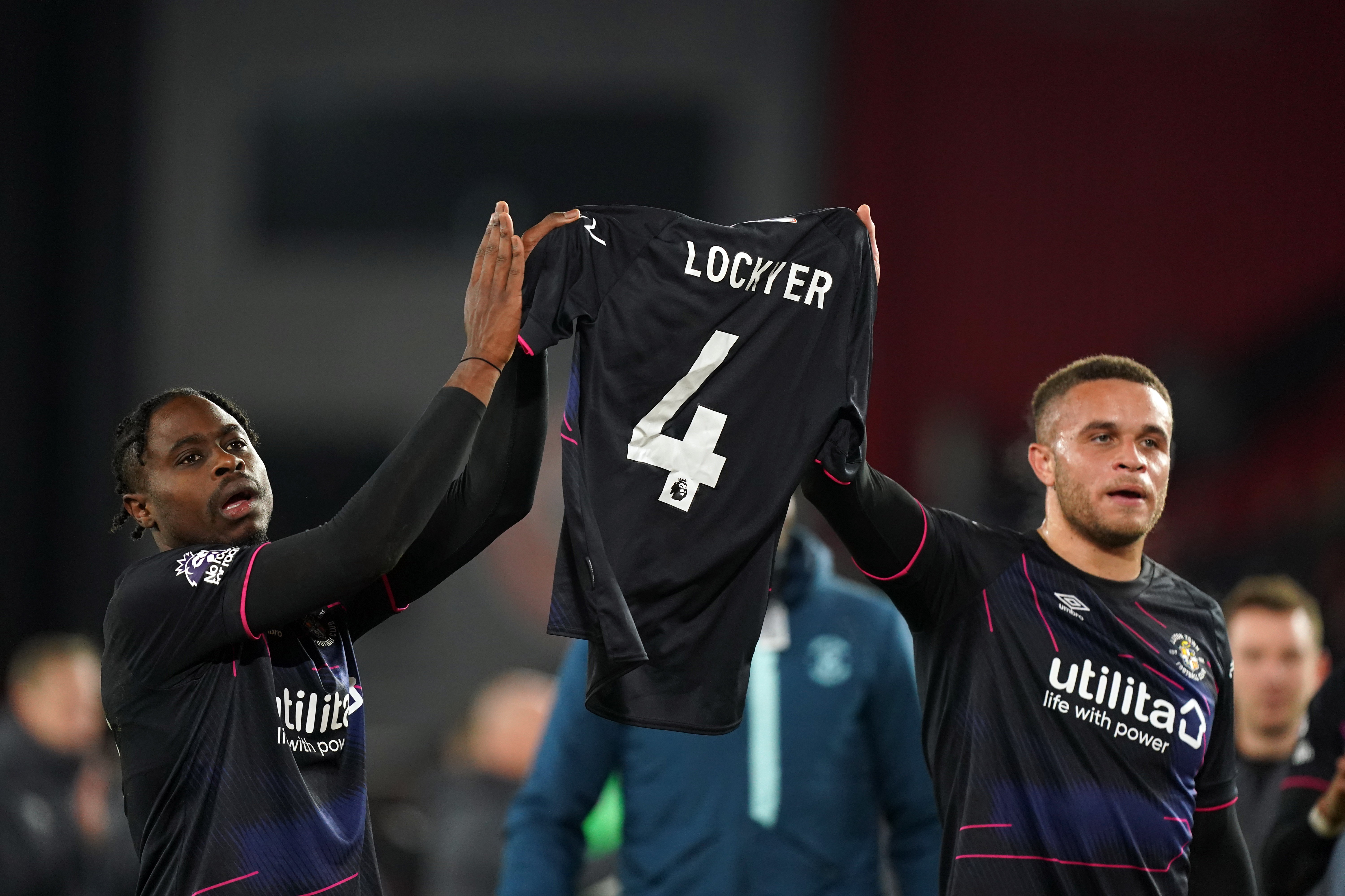 Luton's Pelly Ruddock Mpanzu and Carlton Morris celebrate at the final whistle with a Tom Lockyer shirt