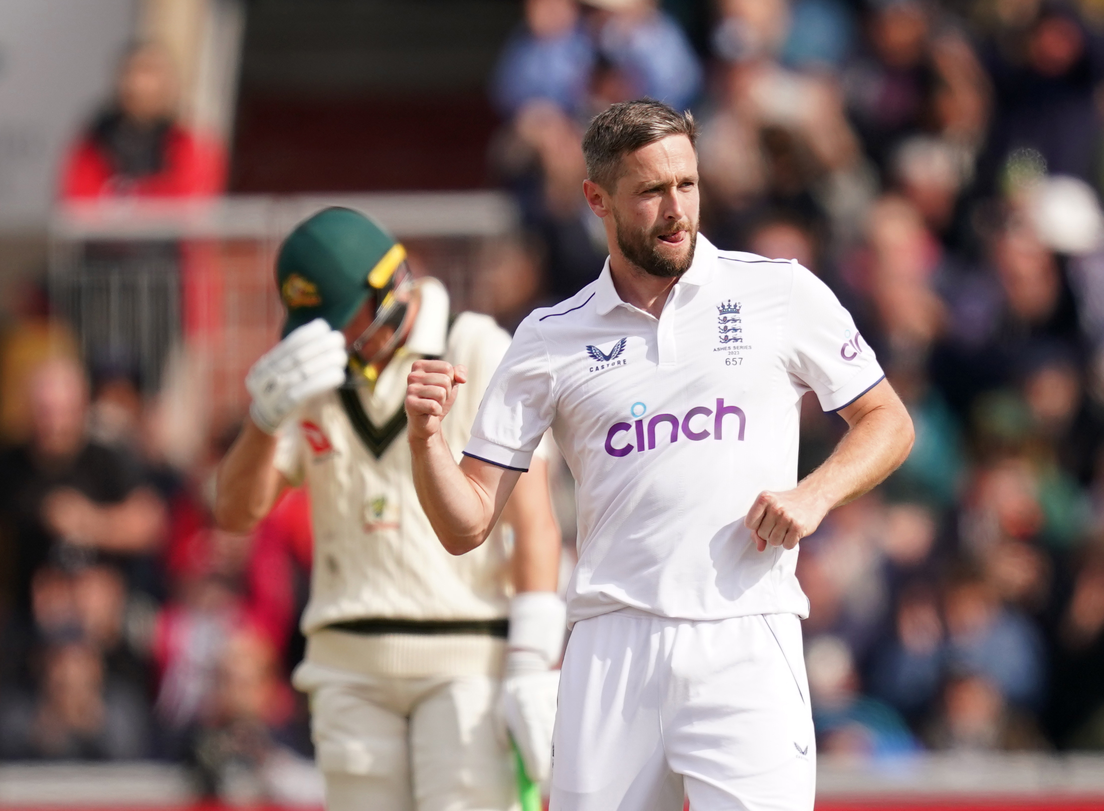 England’s Chris Woakes (right) celebrates the wicket of Australia’s David Warner