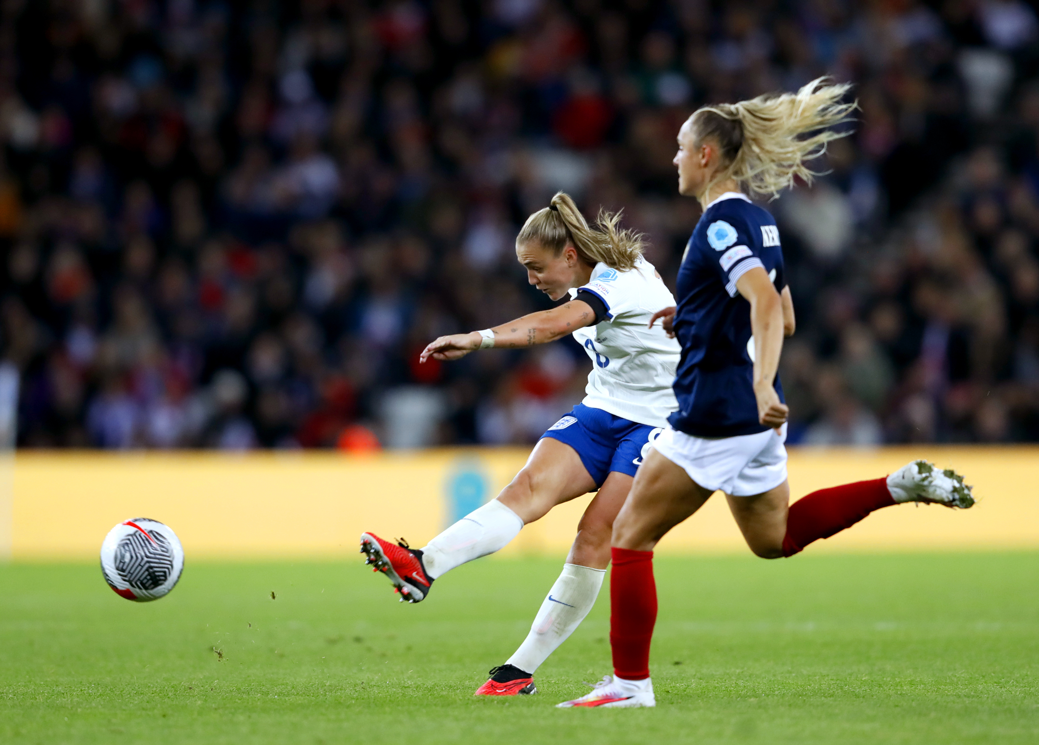 Georgia Stanway, left, shoots from distance against Scotland